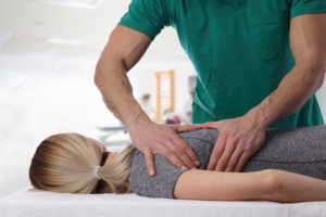 Chiropractor performing treatment on a patient